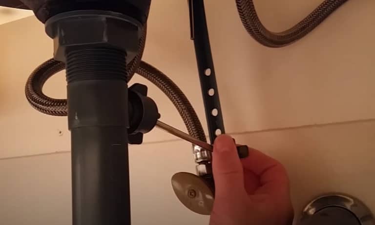 The plunger rod attached to the metal strap and pivot nut