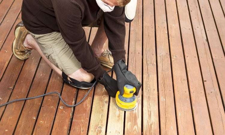 Sanding a wooden deck