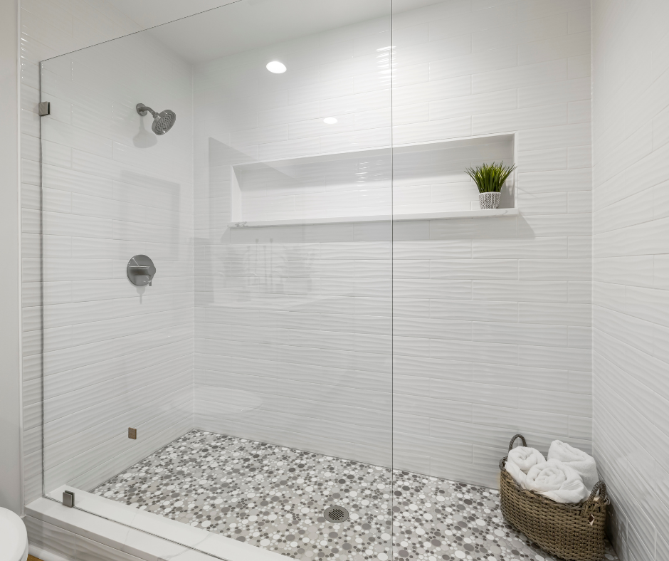 A modern walk in shower with recessed lighting and natural light