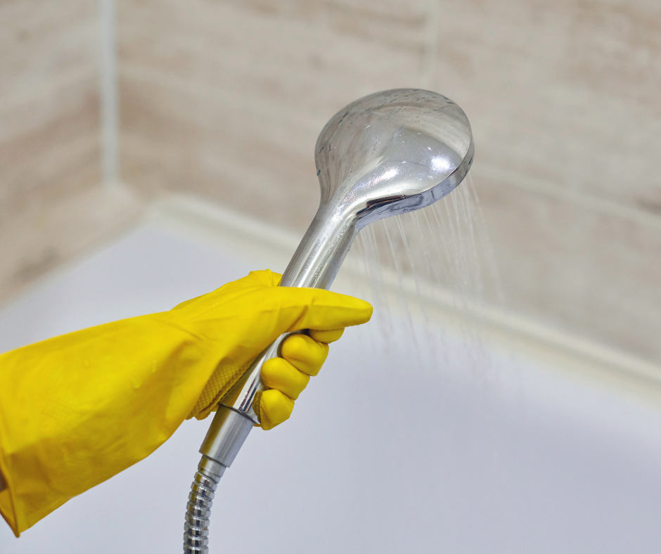 A person adjusting the spray settings of an Oxygenics shower head