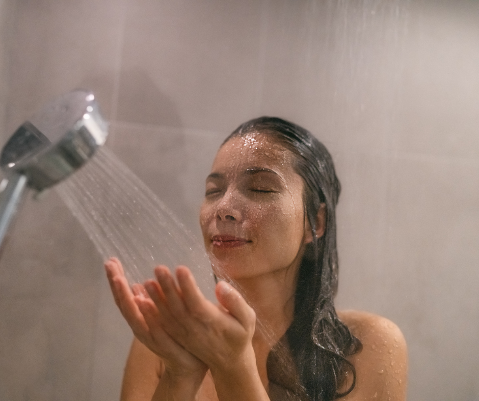 A person choosing the right showerhead for a 30" wide shower stall