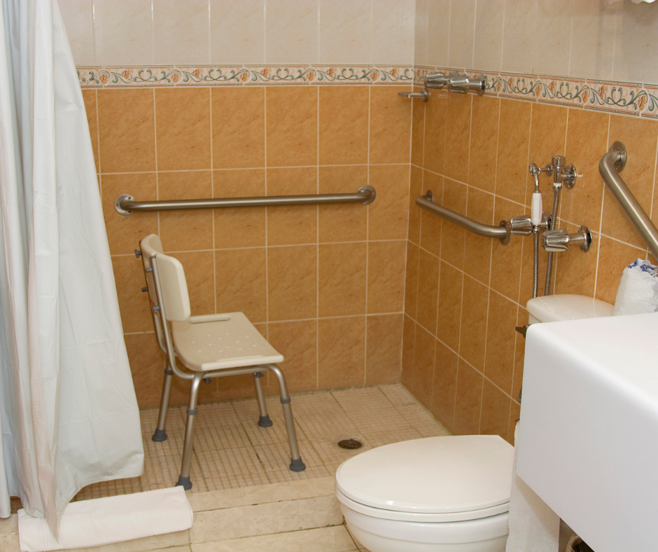 A person standing in a 60 x 30 shower unit with grab bars on the wall