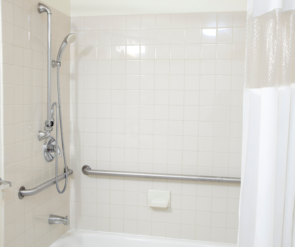 A person standing in a 60 x 30 shower unit with grab bars