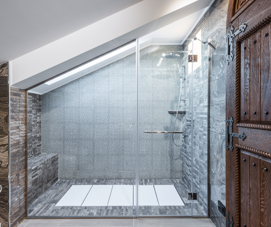 A walk in shower with glass walls and a shower head