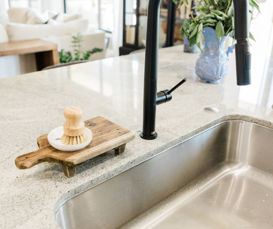 A classic and timeless kitchen faucet with a long neck and pull out sprayer