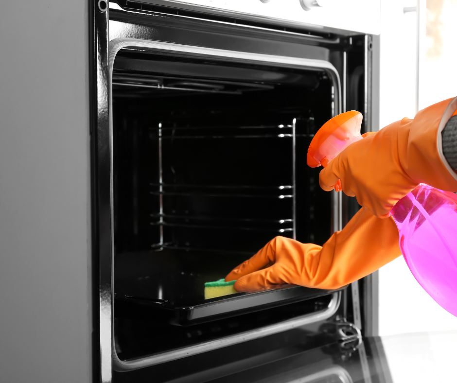 A person cleaning a convection oven pan