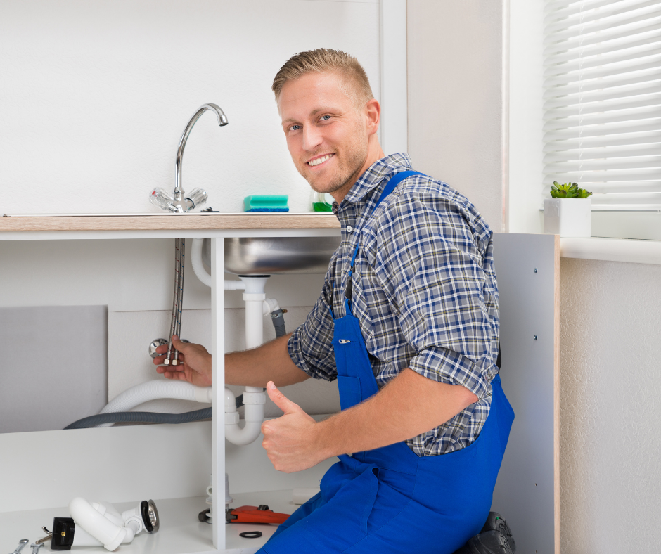 A person fixing a faulty diverter on a Moen kitchen faucet