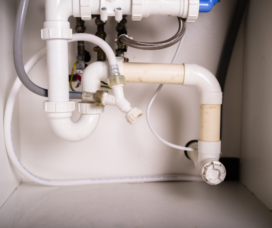 A person inspecting a water inlet valve connected to a Maytag ice maker