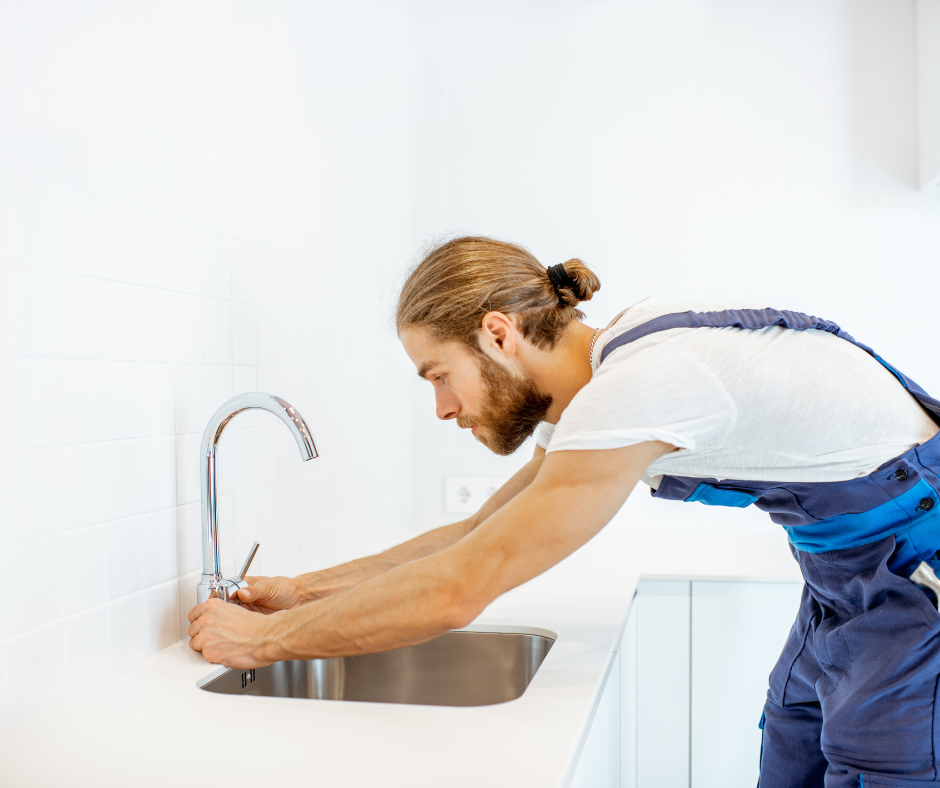 A person performing regular inspections and maintenance to prevent future loose faucet handles