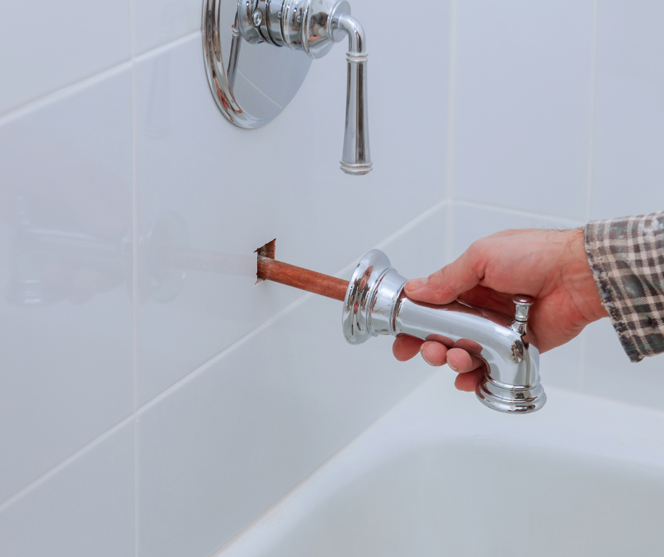 A person repairing a bathroom faucet handle
