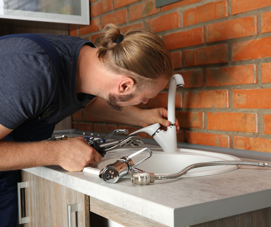 A person replacing worn seals on a Delta kitchen faucet