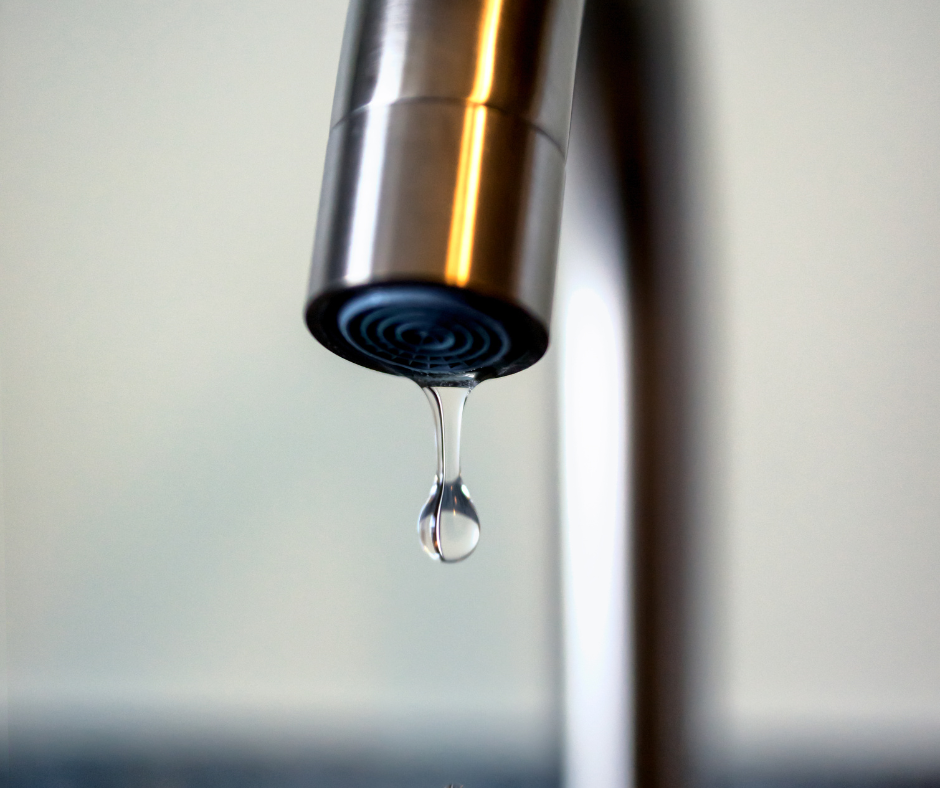 A person troubleshooting a kitchen faucet with low water pressure