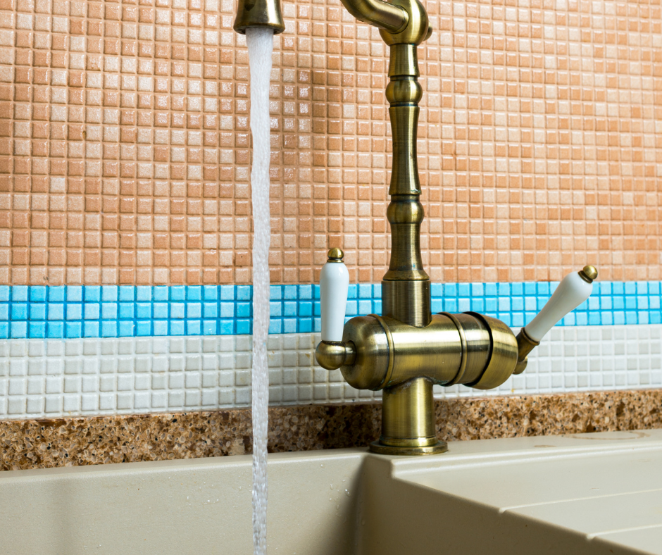 A stylish Moen kitchen faucet with separate handle in bronze tones.