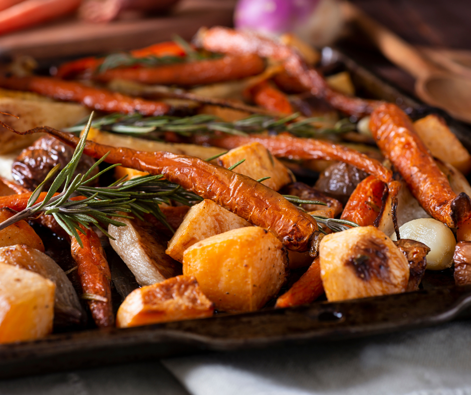 A tray of roasted vegetables with olive oil and herbs